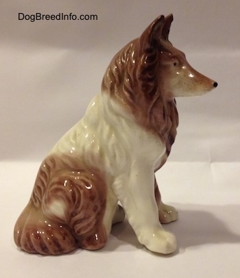 The right side of a brown and white porcelain Rough Collie figurine that has fine hair details.