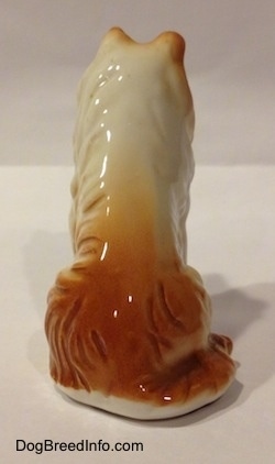 The back of a bone china Rough Collie figurine. It is hard to differentiate the difference between the tail and the body of the figurine.
