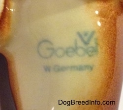 The underside of a Dachshund figurine that has a Goebel W.Germany stamp on it.