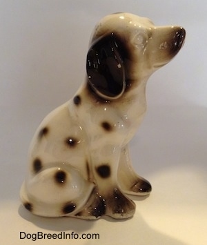 The right side of a Dalmatian in a sitting pose figurine. The figurine has no eye paint.