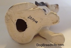 The underside of a Dalmatian figurine that has a hole in the bottom and above the hole is the name - JAPAN.