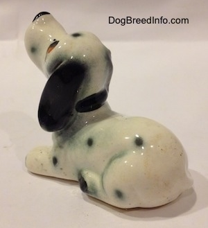 The back left side of a Dalmatian puppy figurine.
