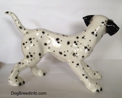 The right side of a Dalmatian figurine. The figurine has a short tail that is arched up.