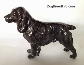 The left side of a blue roan English Cocker Spaniel figurine. The figurine has a small tail.