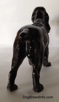 The back of a figurine that is of a blue roan English Cocker Spaniel figurine. The figurine has a short tail.