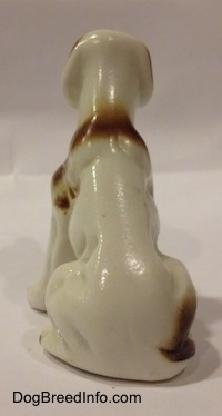 The back of a bone china white with brown bone china English Setter figurine. The back of the figurine is glossy.