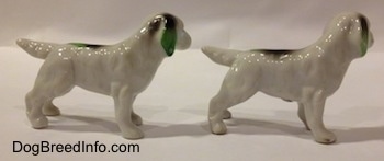 Th right side of two bone china white with green and black English Setter figurines. The figurines have a long body, long legs and short paws.