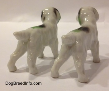 The back right side of two white with green and black bone china English Setter figurines.