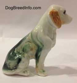 The right side of a bone china English Setter figurine that is in a sitting pose. The figurine has brown ears.