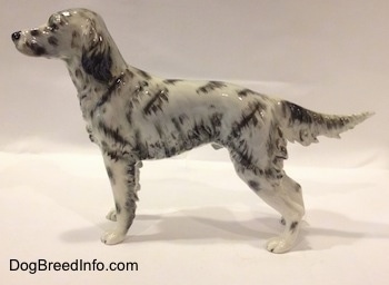 The left side of a white and black English Setter porcelain figurine.