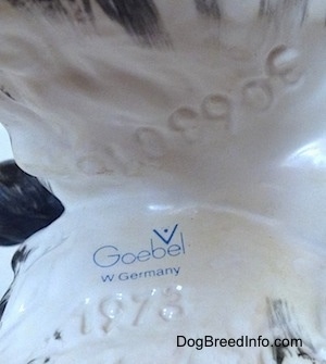 Close up - The underside of a English Springer Spaniel figurine. On the figurine is the stamp of Goebel W.Germany, above and below it are the numbers - 306301 - and - 1973.