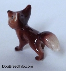 The back left side of a Baby Fox figurine. The figurine is glossy.