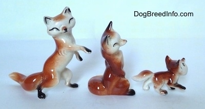 The right side of three different Fox figurines. Each figurine has a white chest.