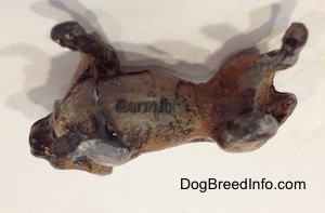 The underside of a metal French Bulldog figurine. On the underside there is a stamp that reads - Germany.