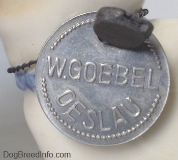 Close up - On a silver medallion it has the words - W.Goebel Oeslau - engraved into it.