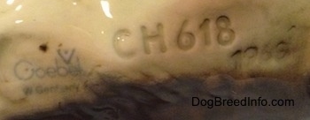 Close up - The underside of a German Shepherd figurine with an engraving that reads 'CH618' and the stamp of Goebel W.Germany.