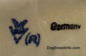 Close up - The crown mark stamp of Goebel W.Germany, a registered ® mark stamp and the word Germany are stamped on the underside of a figurine.