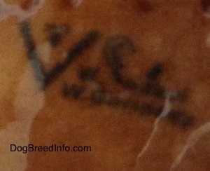 Close up - The underside of a brown figurine that is glossy and stamped on it is the full bee inside the v logo and to the right of that is the stamped words - © W.Goebel W.Germany.
