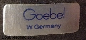 Close up - The Goebel W.Germany sticker on the bottom of a dark figurine.