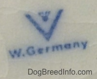Close up - The underside of a white figurine with the full bee inside the v logo under that is the words - W.Germany.