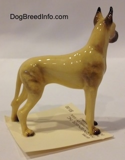 The right side of a tan with black Great Dane figurine. The figurine has a detailed body.