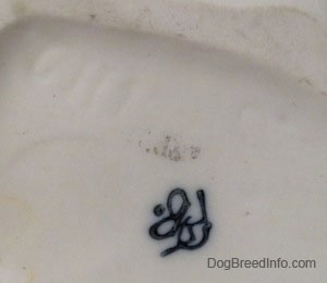 The underside of a figurine that is of a Goebel Double crown mark stamp on it.