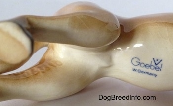 The underside of a tan Great Dane figurine that has the stamp of Goebel W.Germany stamped on it.