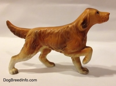 The right side of a ceramic brown with tan Irish Setter figurine with a flat finish and it is pointing.