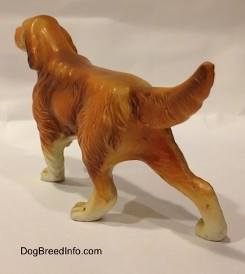 The back left side of a brown with tan ceramic Irish Setter figurine. The figurine has fine hair details across its body.