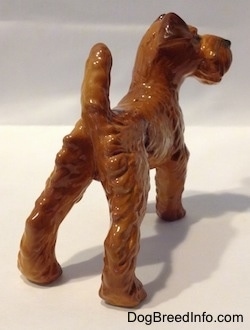 The back right side of a Golden red Irish Terrier figurine. The figurine has small paws.