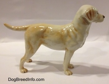 The right side of a yellow Labrador Retriever figurine. The figurine has fine body details.