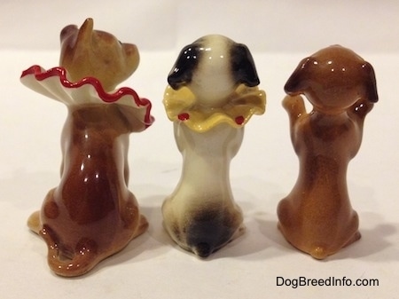 The back of three circus dog figurines.