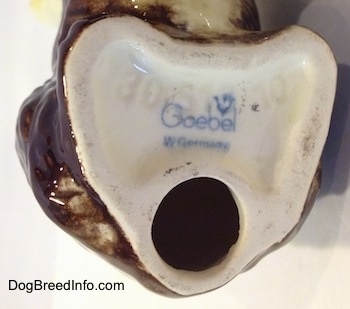 Close up - The underside of an Old English Sheepdog figurine and there is the logo of Goebel W.Germany.