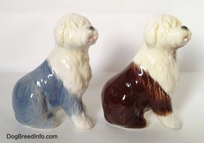 The right side of two porcelain Old English Sheepdog figurines that are in a sitting position. The figures have great hair details.