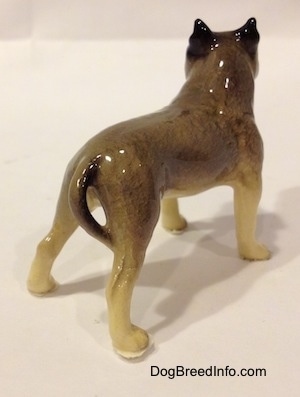 The back right side of a black, gray and white figurine of a Pit Bull Terrier. The figurine is glossy.
