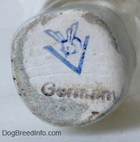 Close up - The underside of a figurine of a Poodle. There is the stamp of Goebel W.Germany on the bottom and under that is the black stamp of Germany.