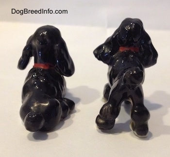 The back of two figurines of bone china black with white figurines. The figurines have large black ears.