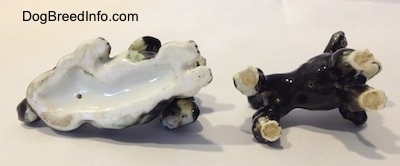 The underside of two bone china Poodle figurines. Both of the figurines have nothing on the bottom.
