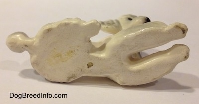 The underside of a white ceramic Poodle figurine.