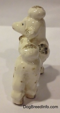 The back of a porcelain Poodle figurine. It is hard to differentiate the ears of the figurine from the head.
