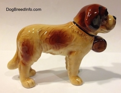 The right side of a figurine of a Saint Bernard porcelain figurine. The figurines ears are hard to differentiate from the head.