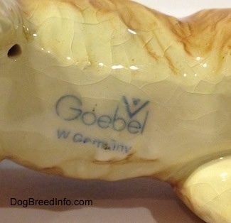 Close up - The underside of a Saint Bernard figurine. The figurine has the logo of Goebel W.Germany stamped on the bottom.
