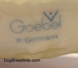 Close up - The underside of a Saint Bernard figurine. The figurine has the blue stamp of Goebel W.Germany on it.