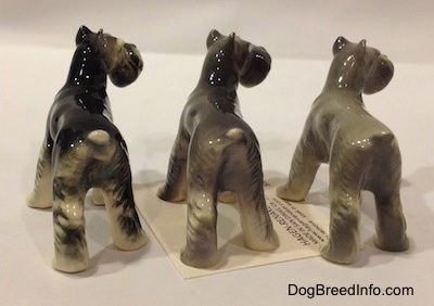 The back of a three color variations of a figurine of a Miniature Schnauzer. The figurines are glossy.