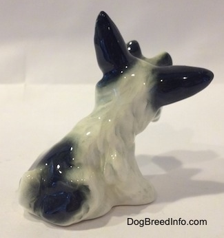 Back side view of a black and gray ceramic figurine with large black ears