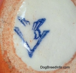 Close Up - The underside of a figurine of a Scottish Terrier. The figurine has the full bee inside the V logo of Goebel W.Germany.