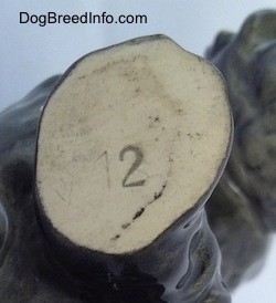 Close up - The bottom of a Scottish Terrier figurine. On one of the legs is the number 12.