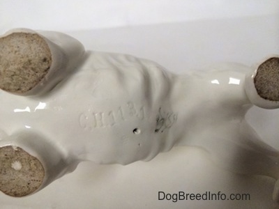 The underside of a Sealyham Terrier figurine. The figurine has the crown mark stamp of Goebel W.Germany on the underside.