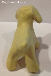 The back of a ceramic white dog figurine.