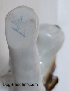 Close up - The blue full bee inside the V stamp of Goebel W.Germany is on the underside of the leg of a Wire Fox Terrier figurine.